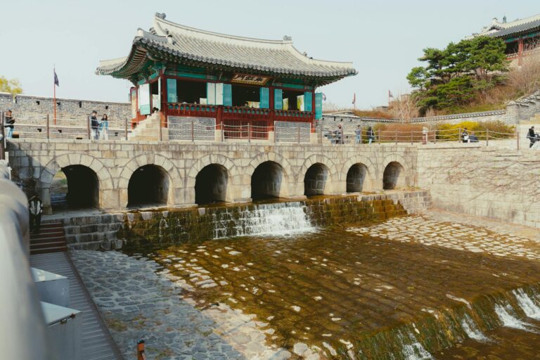Explore the charm of a traditional Korean pavilion overlooking a serene stream in Seoul, South Korea.